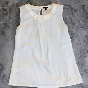 White silky tank with a bow design in middle